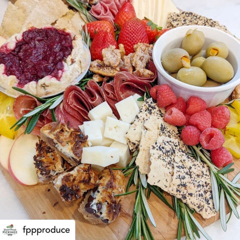 healthy charcuterie board with mats, crackers and fruit