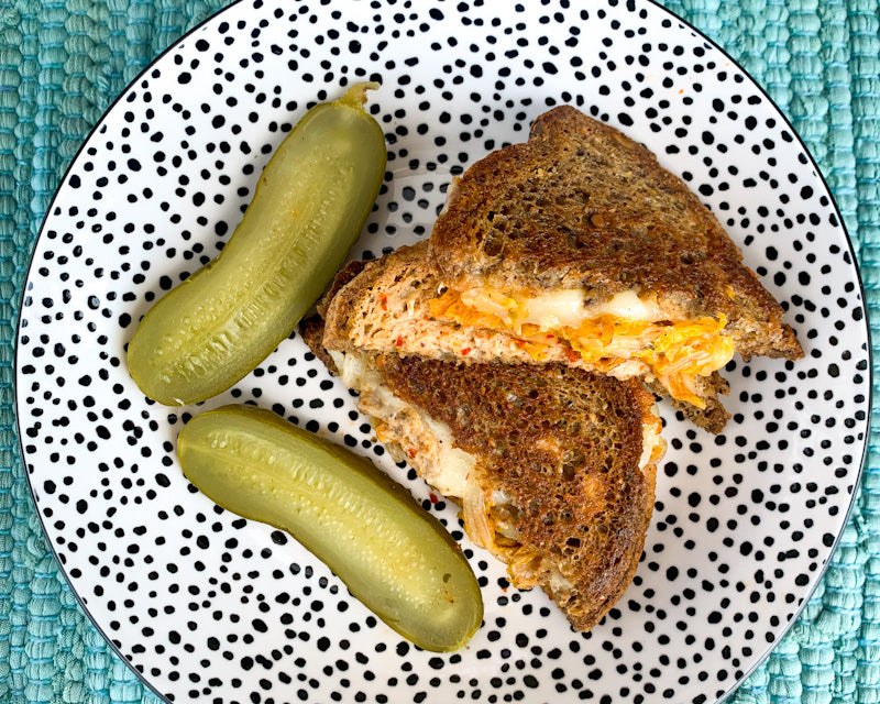 Grilled Cheese Sandwich with kimchi and a pickle on the side
