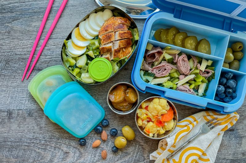 flat lay view of bento boxes with plastic reusable bags