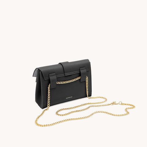 a designer bag styled with gold chain