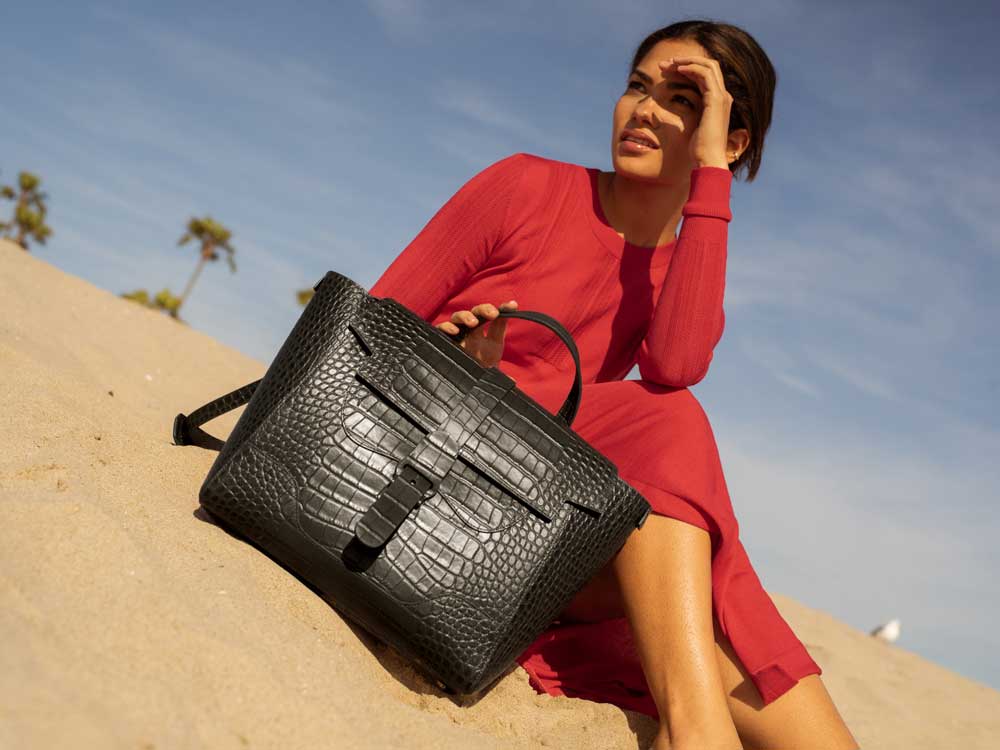 Woman with Black Handbag on Beach