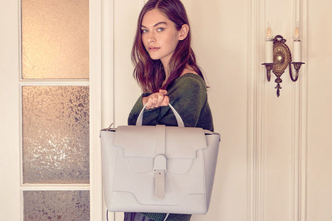 Model holding up maestra purse