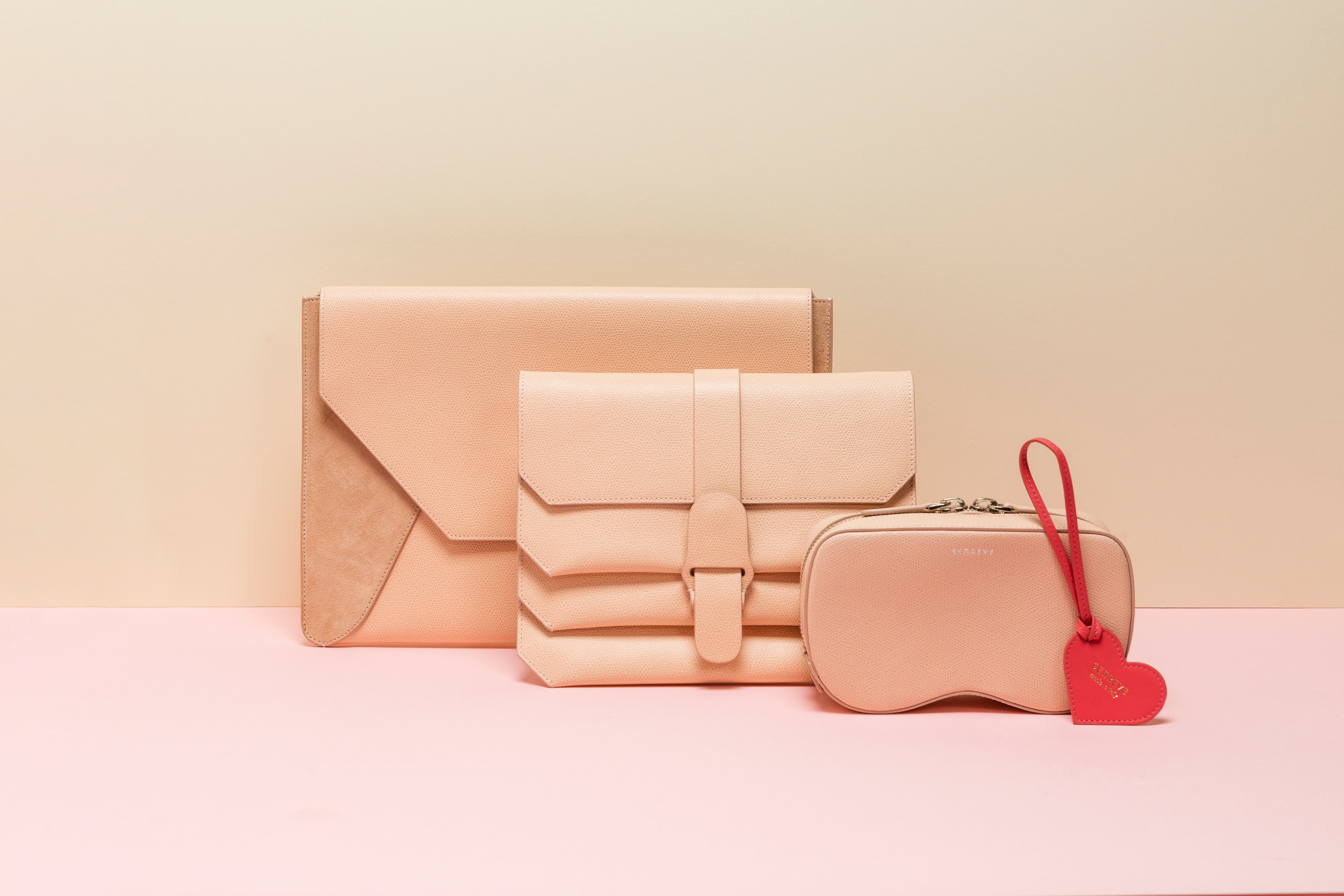 Envelope Laptop Sleeve in Mixed Leather Suede Blush, Crossbody in Pebbled Blush, Coda Belt Bag in Pebbled Blush, Heart Charm in Rose