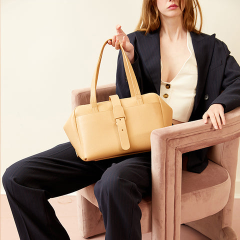 SENREVE model holding yellow Doctor bag