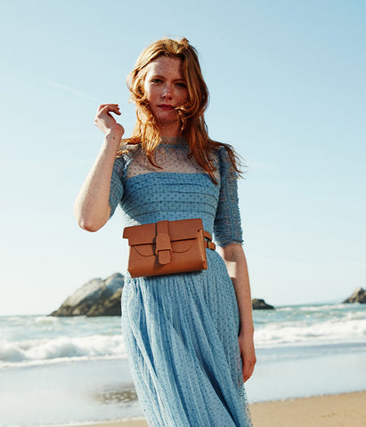 Model wearing a brown leather belt bag