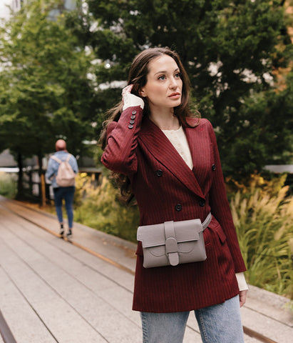 woman wearing blazer and designer fanny pack