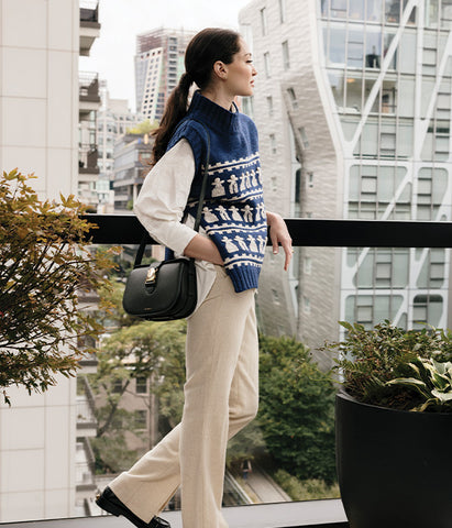 woman wearing holiday outfit and designer purse