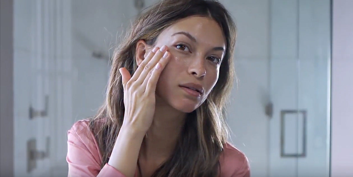 Woman applying moisturizer