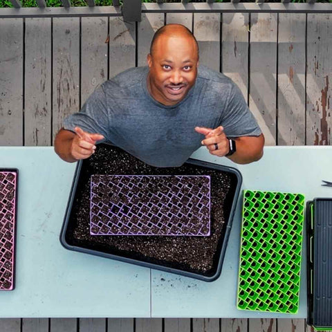 Overhead view of Milan Turner starting his seeds in 72-cell air prune trays.