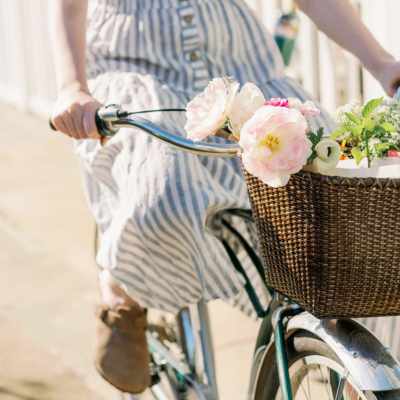 girl making a floral delivery on bicycle