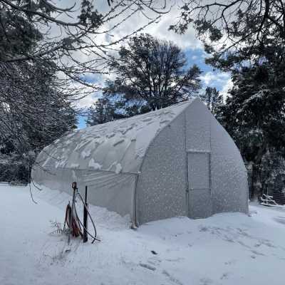 Frost Free Hydrant Installed near a Gothic Hoop House in the Winter