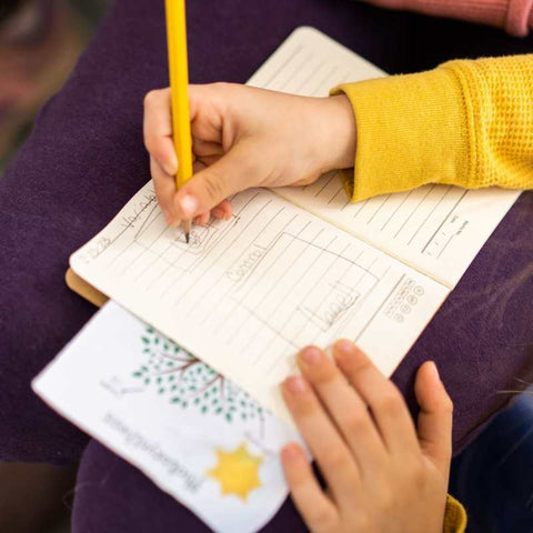 Student writing in journal