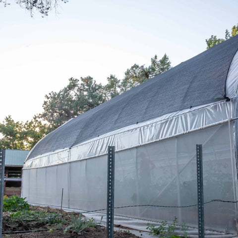 Rollup Side Wall Ventilation on a Hoop House with a Gothic Arch. Shade cloth is installed over the top of the hoop house with shade cloth clips.