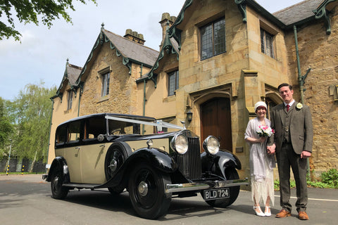 The bride and groom wearing their 1920s outfits, bride in Anna Chocola cloche hat