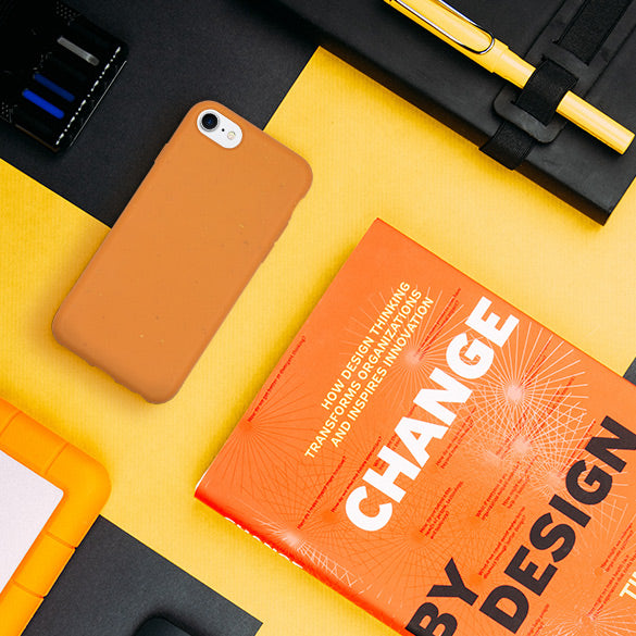 Orange Biodegradble Phone Case and a book