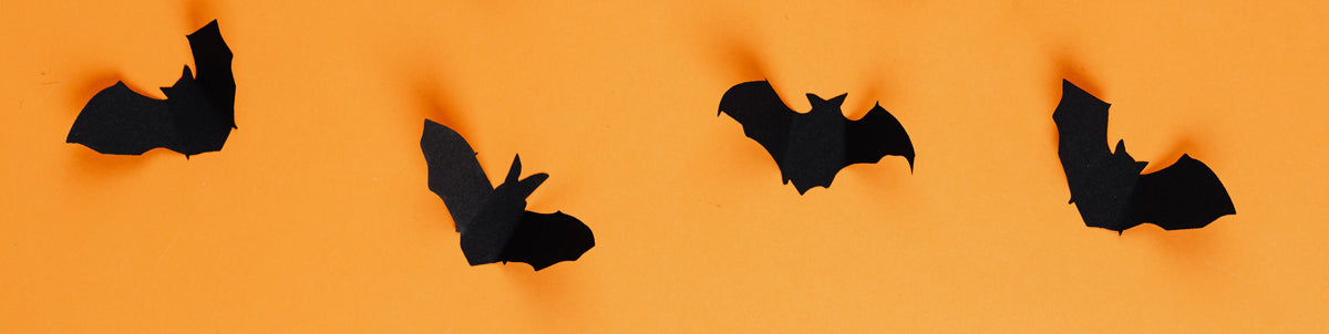 Orange background with paper bats