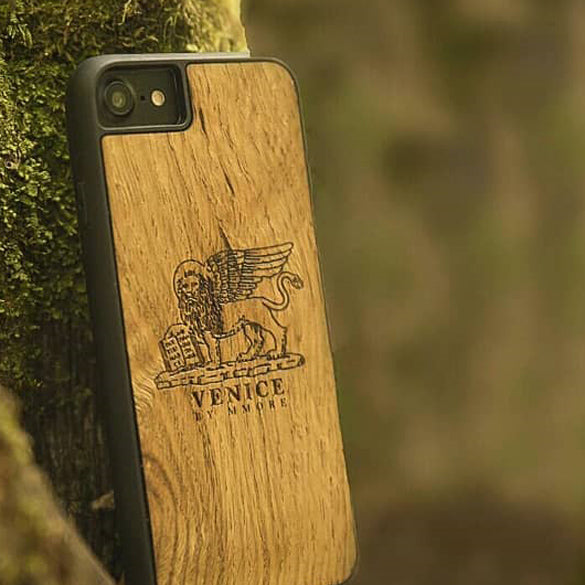 The Venice Lion phone Case resting on a tree