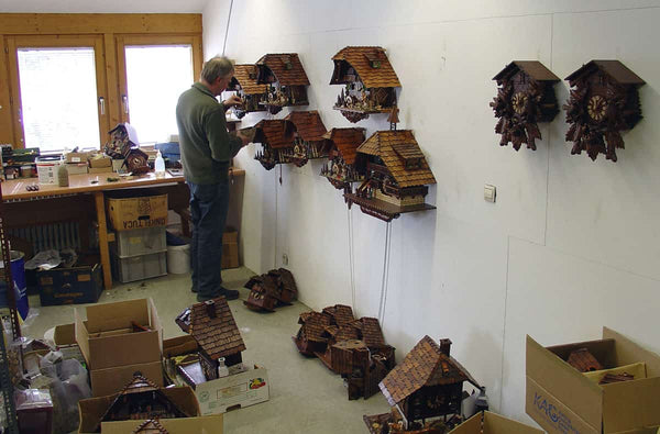 Cuckoo Collections presents August Schwer workshop man adding detail to cuckoo clocks