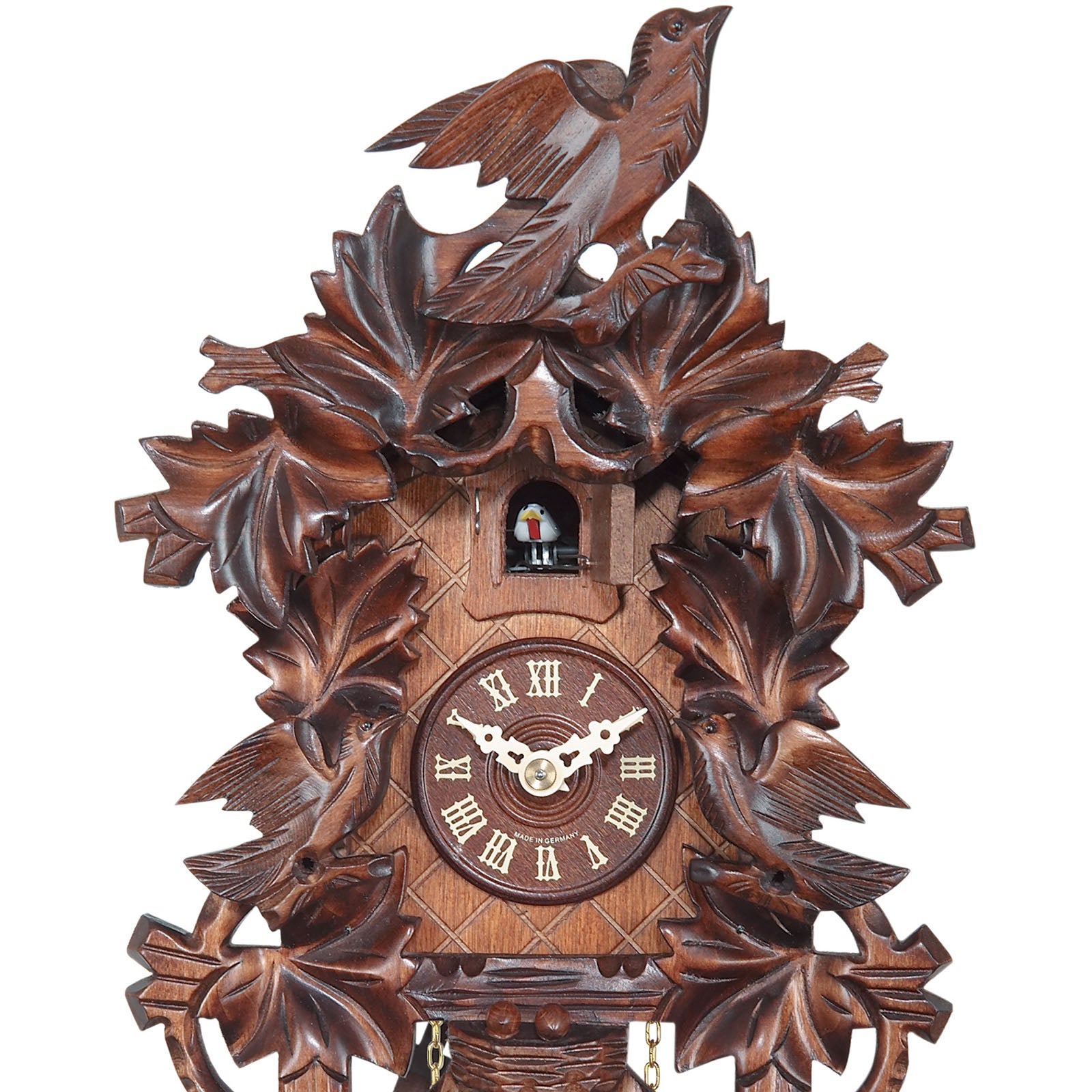 Carved batterypowered cuckoo clock with large cuckoo bird, two smalle