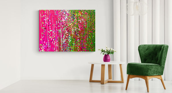 Cerise pink & moss green abstract canvas print on white wall next to small table and green velvet chair