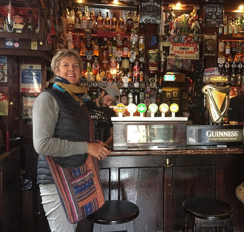 Tourist enjoying Dublin's famous Temple Bar, wearing down jacket from wildkiwiclothing.co.nz