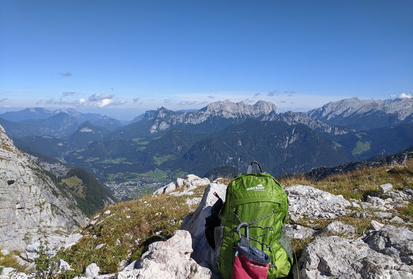 Green packable Wild Kiwi backpack, in Austrian Alps