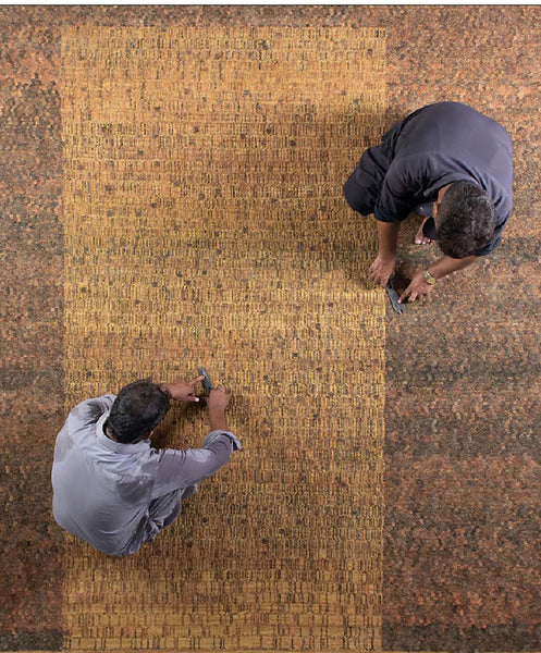 Workers finish a Battilossi rug