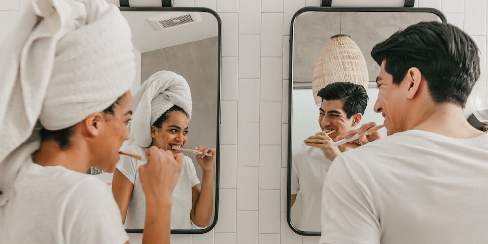 A couple brushing their teeth