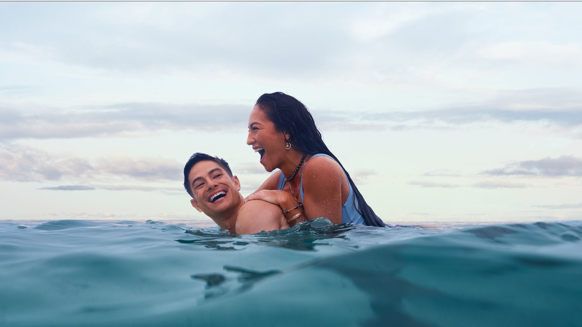 A couple laughing in the ocean