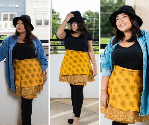 A beautiful model wearing the same outfit (black leggings, a golden skirt, a black shirt, a black hat, and a denim jacket) posing 3 times against the same white wall. 