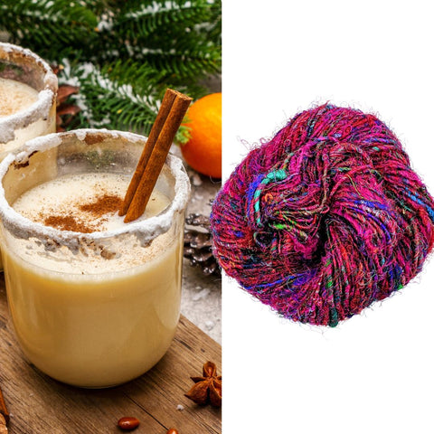 A warm glass of eggnog on the left, with a nest of multicolored premium silk yarn on the right