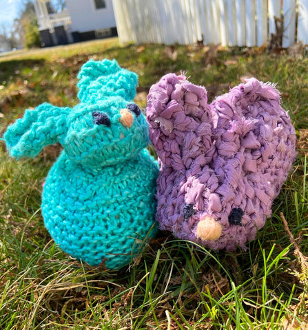 Two Bunny amigurumis sitting in some grass. One is made with Darn Good Yarn Silk Roving Worsted Weight while the other is made using chiffon ribbon.