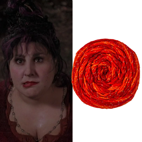  The character Mary Sanderson on the left, and to the right of the image is a cake of sparkling red and orange worsted weight silk yarn