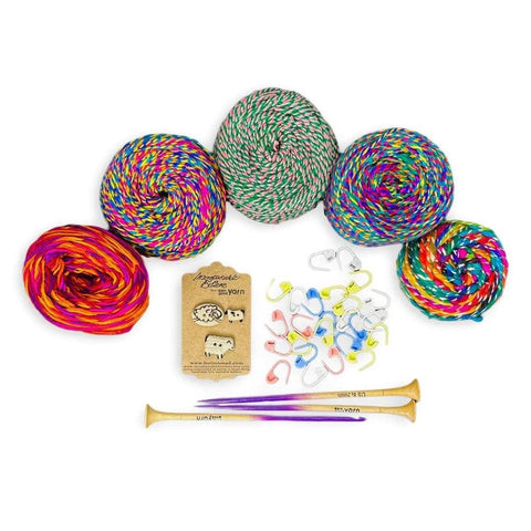 Knitting stocking stuffers for crafters who love colorful projects, colorful yarn and knitting needles with stitch markers and sheep buttons.