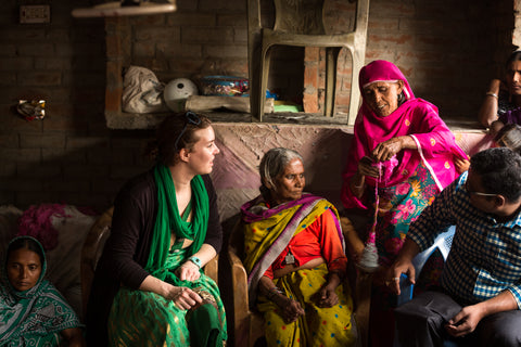 Founder Nicole learning about spinning fibers at a co-op in India.