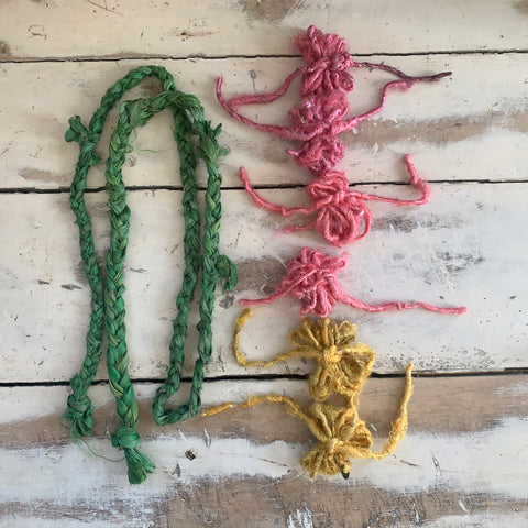 Completed assemblies: (2) sari silk ribbon braids and (6) tied loops of banana fiber yarn