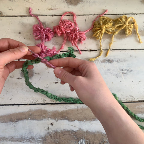 Tying banana fiber flower tails together