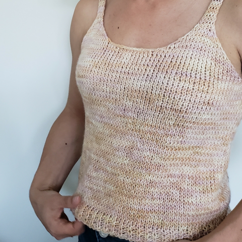 Close up of woman wearing the knit Hampton Top in front of a white wall