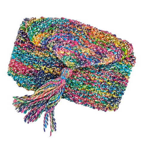 A tasseled clutch made of brightly colored white rainbow handmade silk yarn.