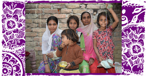 Purple and white mandala illustrated background with a photo of 2 women and 3 children wearing saris and sitting in front of a brick wall