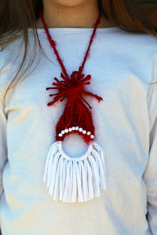 Close up view of woman wearing a handmade santa necklace