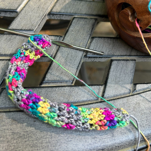 An up close shot of a work in progress hair ribbon made from peek a boo lace weight silk yarn