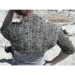 Back view of woman wearing Abask Shrug in gray while sitting on a rock