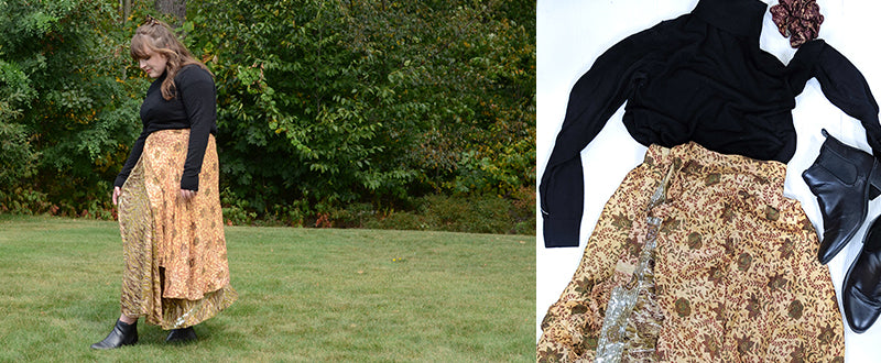 women wearing a black turtle neck with a golden sari wrap skirts with fall flowers and black booties standing in the grass