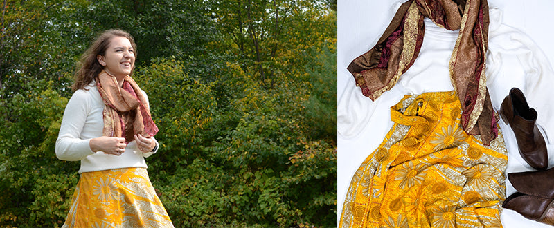 women wearing a yellow sari wrap skirt with sunflowers, a white sweater and a recycled sari scarf around her neck