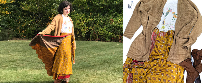 women wearing a yellow floral sari wrap skirt with a copper underskirt, a graphic tshirt with floral print, and a chunky cardigan in the grass wearing brown boots. There is also a flat lay with this outfit o na white background.