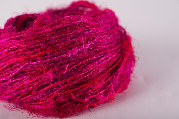 close up of vibrant red yarn skeins