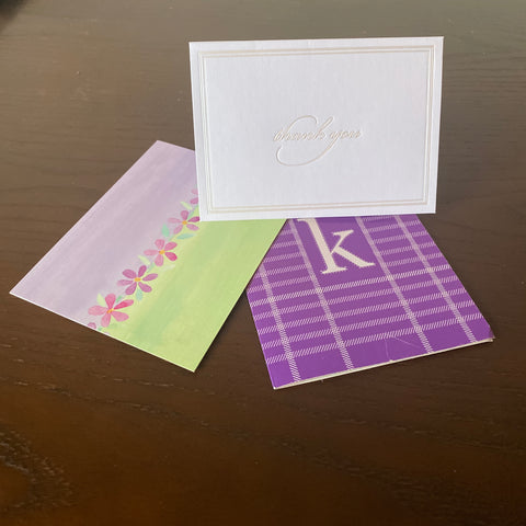 Three different colored cards are laid out on a dark wooden table.