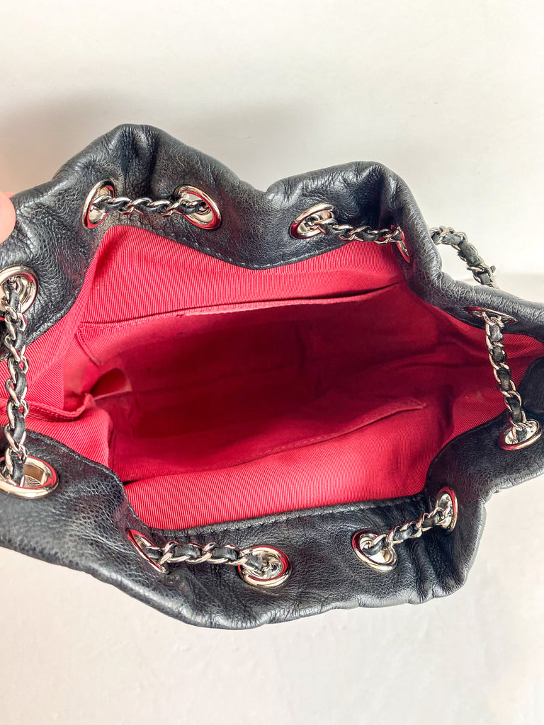 black bucket bag with red inside