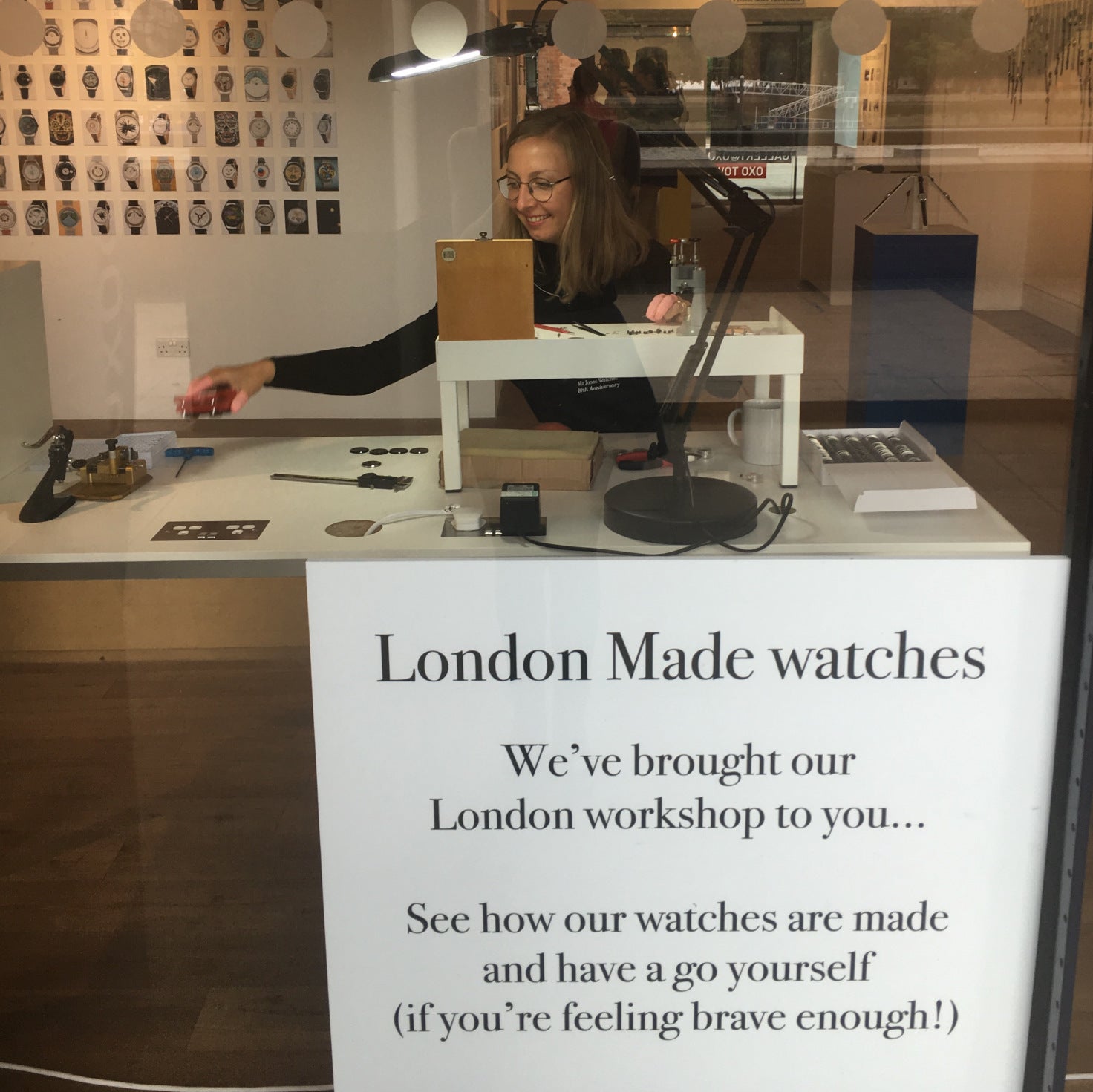 View from the outside window of the exhibition: Dovile assembling watches